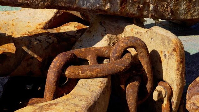 Heavy rusted corroded ship anchor chain links closeup in the seaport in sunny day