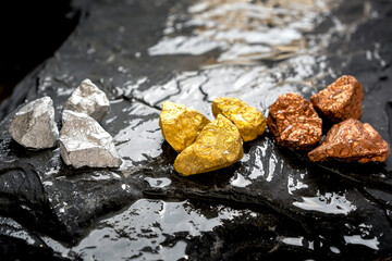lump of pure gold, silver and copper on a rocky ground with flowing water, valuable minerals