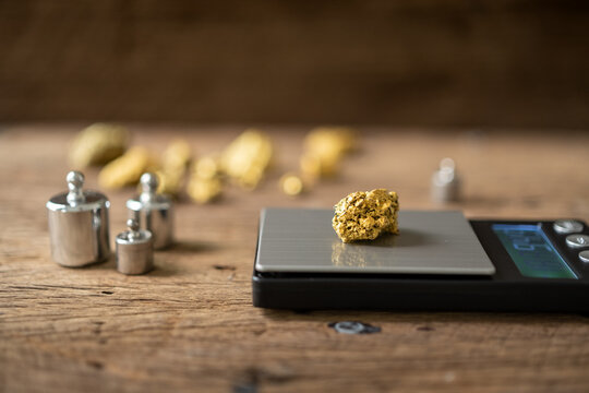pure gold ore from a mine is placed on a weighing scale for evaluation.