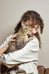 A devoted and gentle cat hugs his owner