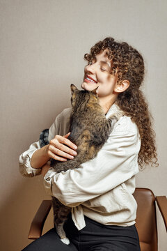 Cute Woman Tries To Hold Her Restless Cat In Her Hands