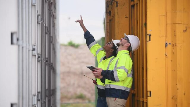 Engineers railway team wearing safety uniform under conversation document on hand inspection survey container boxes railway work station is industry transportation cargo import export concept.