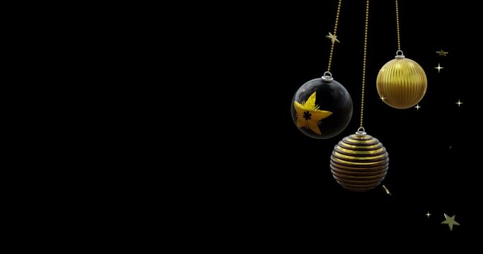 Black and gold christmas baubles swinging with gold stars on black background, copy space
