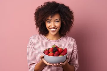 Gordijnen Black woman eating healthy fruit and berries © GustavsMD
