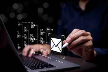 Businessmen use laptops with communication icons, letter icons, email icons, and newsletter email and protect your personal information or spam mail, Customer service call center contact.