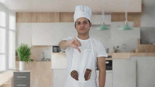 Disappointed Indian professional chef showing thumbs down