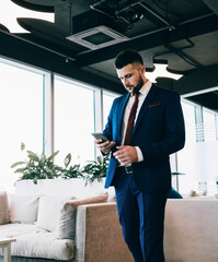 Businessman reading message on smartphone