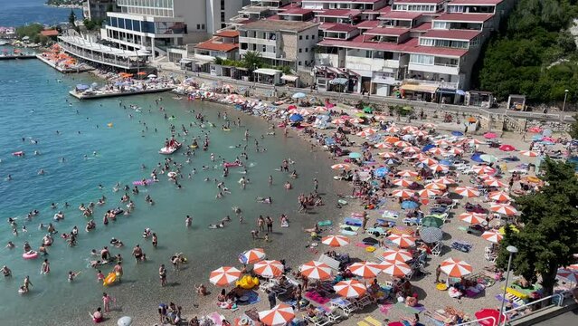 People swimming in shallow sea water during hot summer day