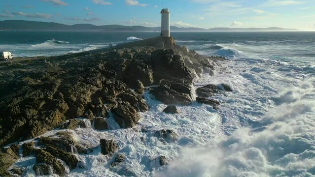 Turbulent Water Crashing On The Rocky Coast Shore Of Faro de Cabo Roncudo In Corme, Coru&ntilde;a, Spain. aerial
