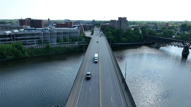 Highway bridge over Mississippi River towards Saint Cloud, MN. Aerial establishing shot on bright summer day.