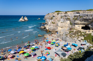 TORRE DELL'ORSO, ITALY, JULY 14, 2022 - View of the beach called of the Two Sisters in the village of Torre dell'Orso, province of Lecce, Puglia, Italy - obrazy, fototapety, plakaty