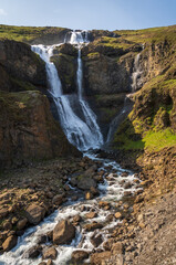 Fototapeta na wymiar Rjúkandi Waterfall During Summer in Iceland