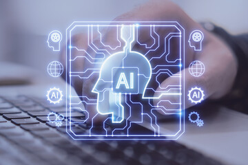 Close up of male hands using laptop keyboard with creative AI head outline hologram with circuit on blurry background. Double exposure.