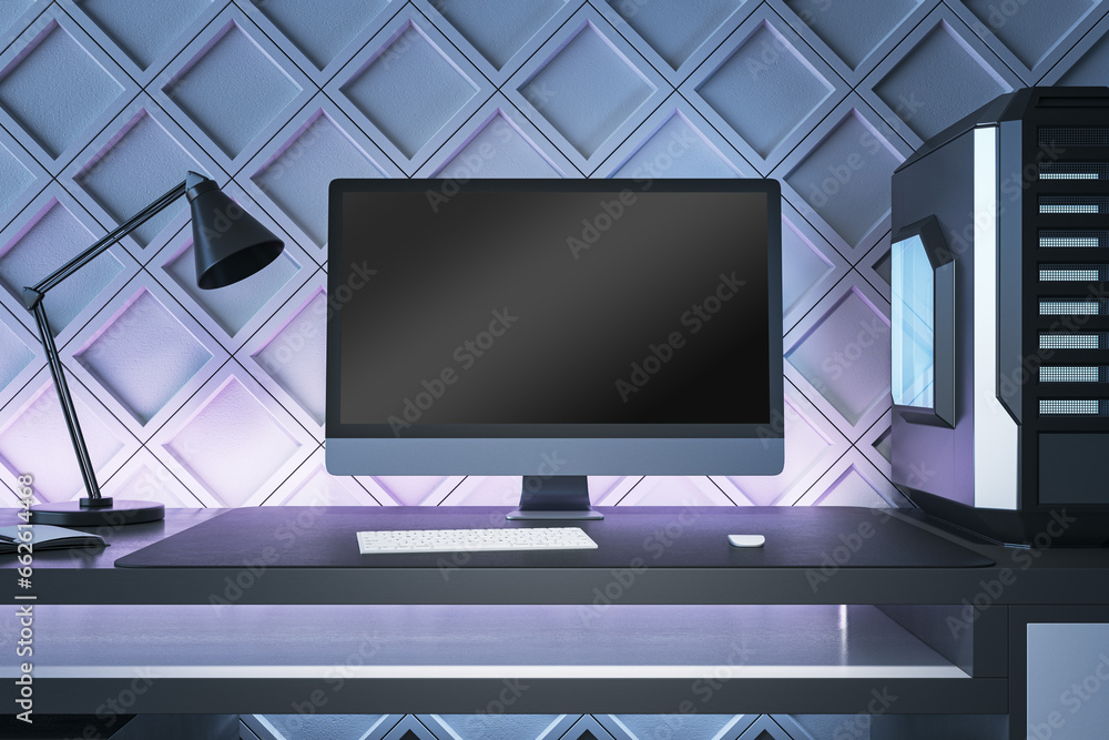 Poster Creative gamers desktop with empty computer screen, lamp and system unit on decorative blue wall background. Gaming concept. Mock up, 3D Rendering.