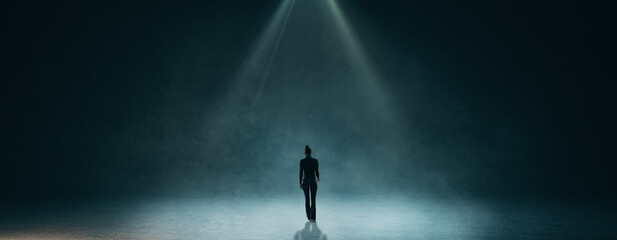 Back view of businessman walking in abstract dark wide interior. Education and smoke room concept.