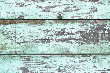 Fototapeta na wymiar Wooden desk peeling paint. Old peeling paint texture. Grunge cracked wall background. Blue color weathered surface. Broken wood structure. Vintage pattern design.