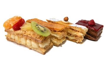 Four very appetizing cakes, isolated on white background.