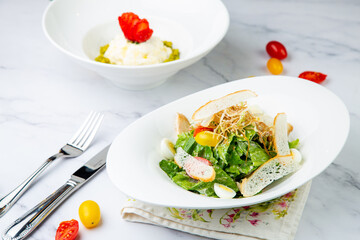 salad with quail eggs, cherry tomatoes, lettuce and breadcrumbs, side view
