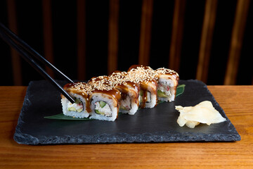 Sushi roll with salmon and shrimps on a sushi tray