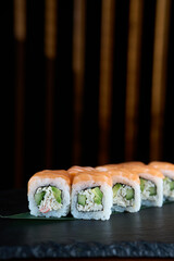 Sushi roll with salmon and shrimps on a sushi tray