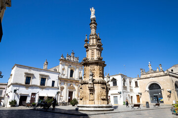 Fototapeta na wymiar NARDO', ITALY, JULY 17, 2022 - View of the church of Saint Tryphon (San Trifone) and the Spire of the Immaculate in the center town of Nardò, province of Lecce, Puglia, Italy