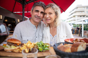 couple having hearty meal on restaurant terrace