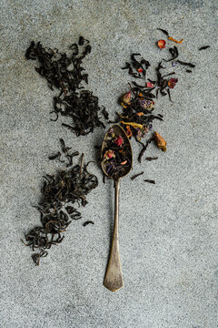 Overhead view of a vintage teaspoon with loose tea leaves