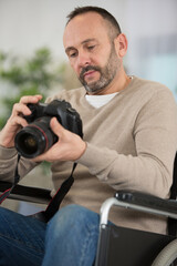 disabled man in a wheelchair using a camera