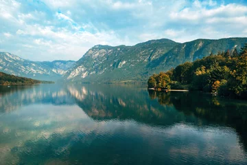 Fototapeten Lake Bohinj surrounded with Julian Alps mountains in Triglav national park in Slovenia © Bits and Splits