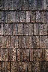 Texture of worn wooden roof tile pattern, detail of a typical old slovenian alpine cottage roofing