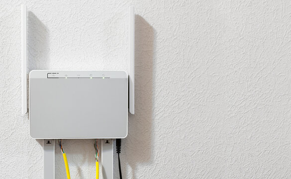 Dual-band home router attached to the wall, copy space