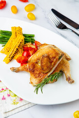 Grilled chicken with tomatoes and corn side view