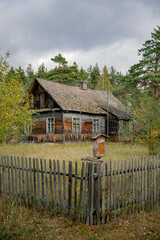 Fototapeta na wymiar Old wooden house in rural russia in the middle of nowhere, old traditional style house surounded by forest