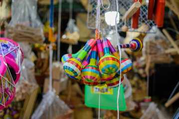 Small maracas made with colorful fibers. Handicrafts in a street market in Mexico.