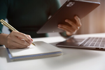 Female businessman thinking ideas strategy working concept at the desk in the office.