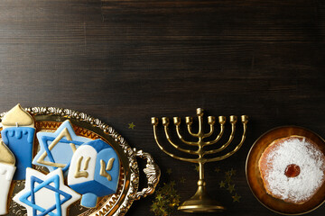 Gingerbread, Hanukkiah and donut on wooden background, space for text