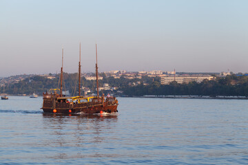 Stylized tourist boat crosses the Sevastopol bay on a summer day