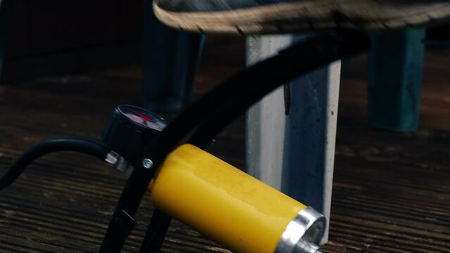 Foot using manual tire pump 