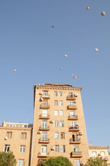 Roof of a house and a hot air balloon in the sky. Residential building and hot air balloon. © Artur Harutyunyan