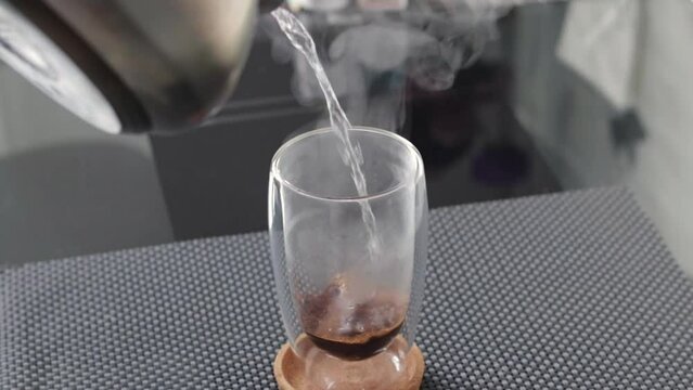 Slow motion footage of the transparent cup of hot steamy coffee. Beverage
