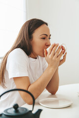 A woman drinking tea in the comfort of her home