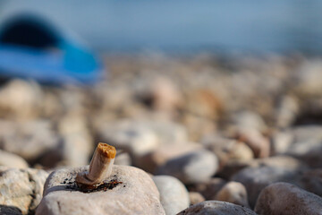 cigarette butt on the beach floor