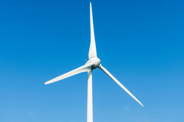 Close-up of wind power systems with the blue sky background.