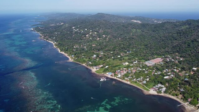 Tropical north coast of Punta Gorda, Roatan Honduras, high aerial view