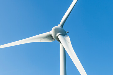 Close-up of wind power systems with the blue sky background.