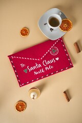 Coffee cup and an orange slice with a Santa Claus note in the center.