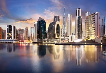 Tuinposter Dubai skyline with skyscraper and reflection in canal - nice cityscape in United Arab Emirates © TTstudio