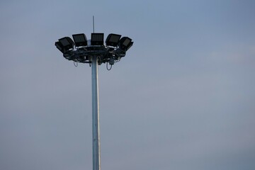 A pole with a large lamp mounted.