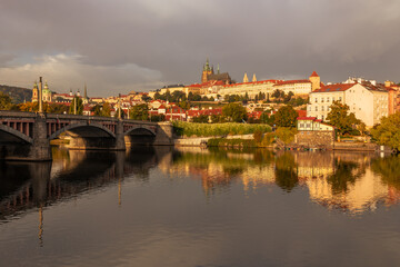Autumn views from Prague. Picturesque autumn Prague in the morning sun. The Vltava River with the Charles Bridge, the waterfront and houses of Mala Strana and the dominant Prague Castle. Czechia