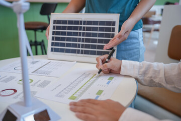 Solar panels green energy Business people working in green eco friendly office business meeting creative ideas for business eco friendly professional teaching corporate people sustainable electricity